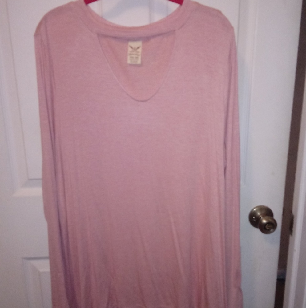 Long sleeve light pink shirt.